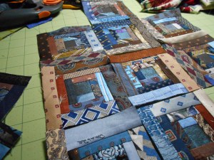 Log cabin block foundations done with blue and brown ties.